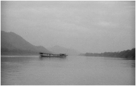 Boat crosses the Mekong river near Luang Prabang, Laos